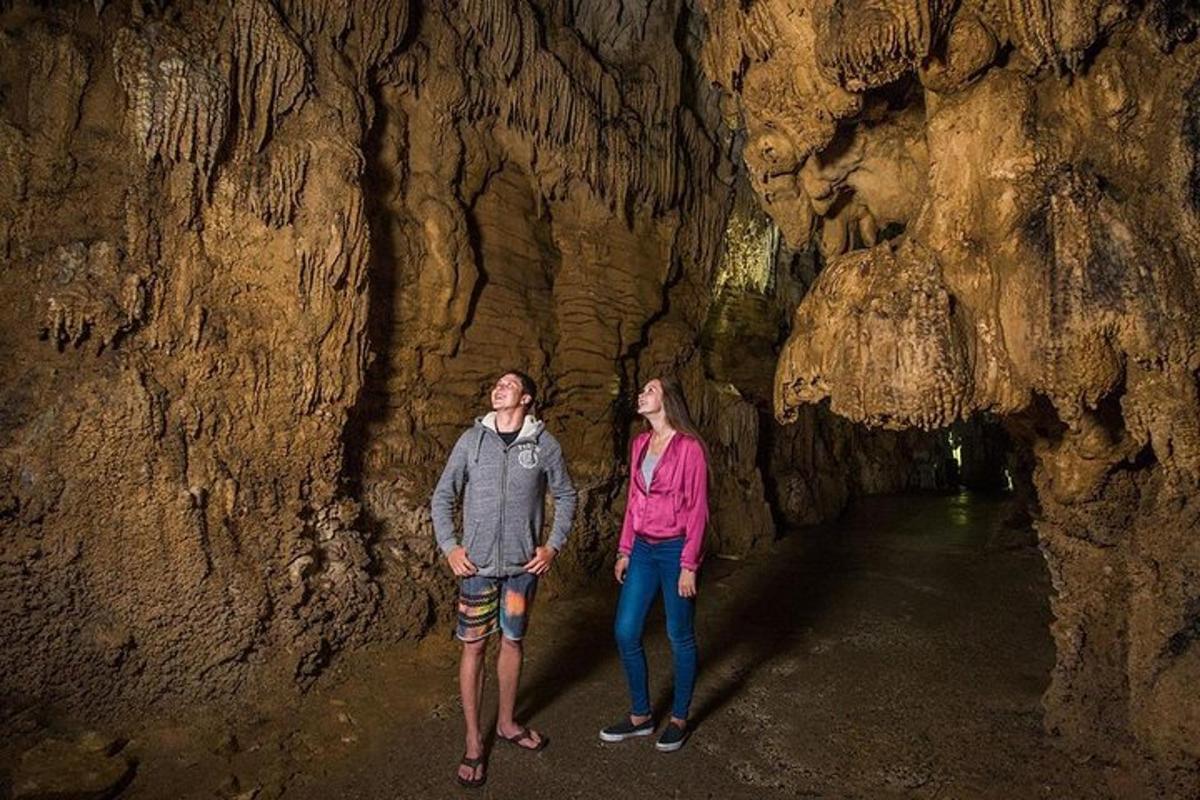 a man and woman standing in a cave