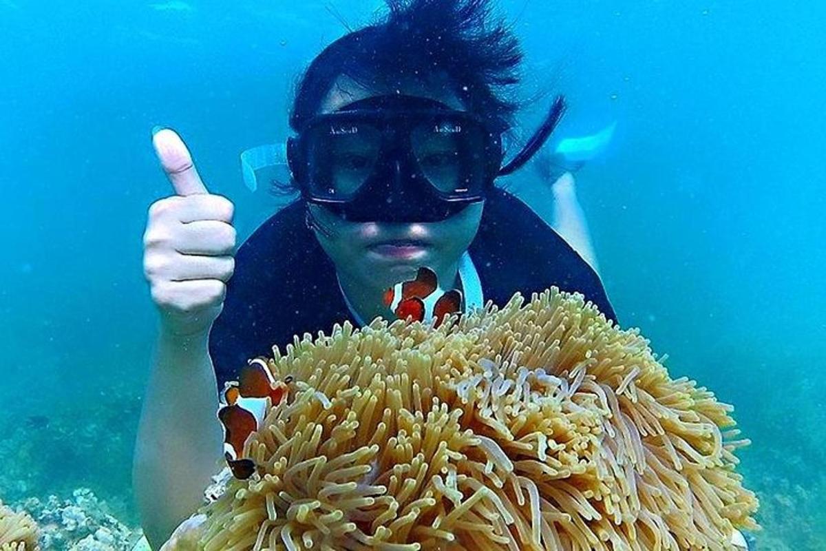 a man giving a thumbs up over a coral reef