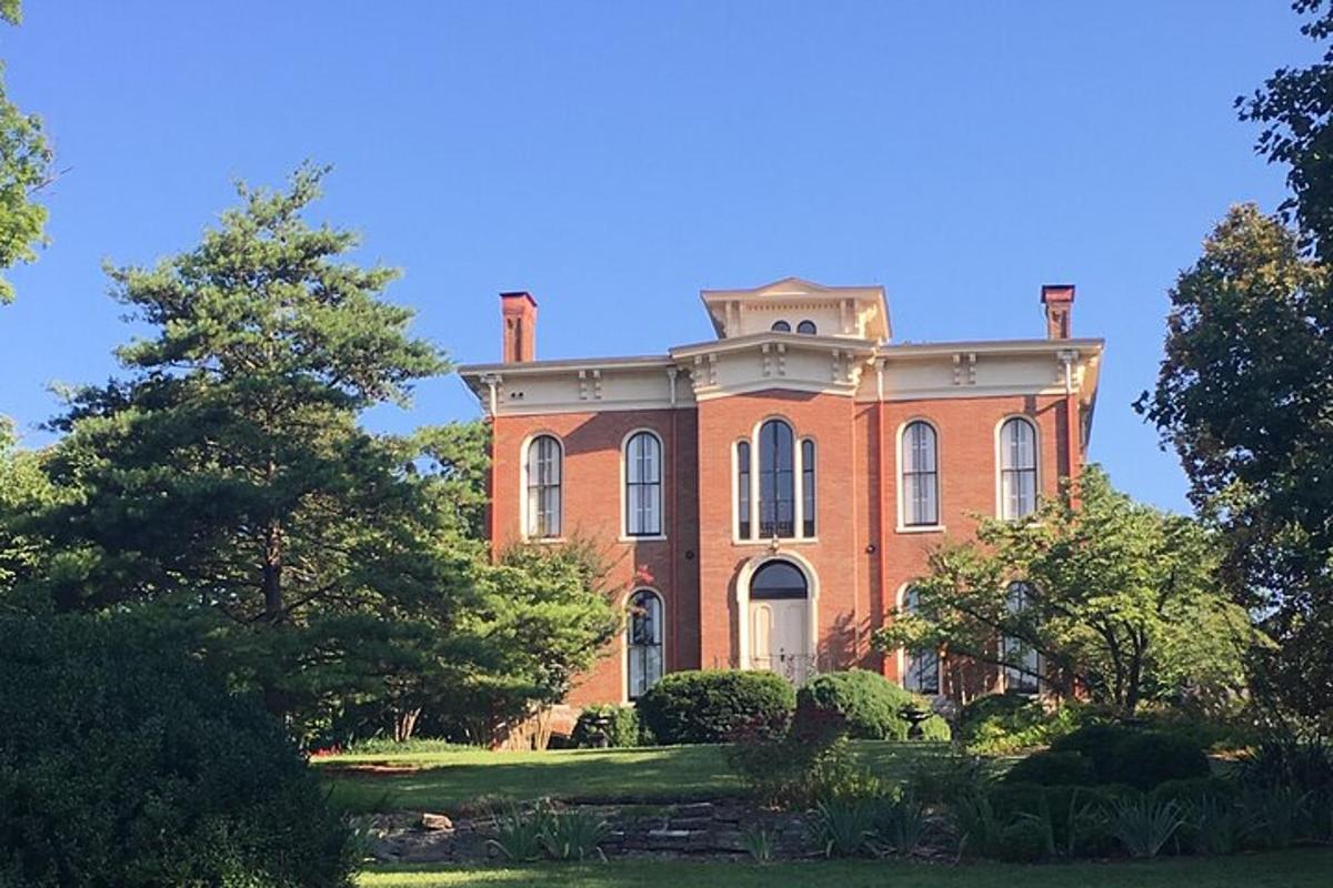 a large red brick house with trees in front of it