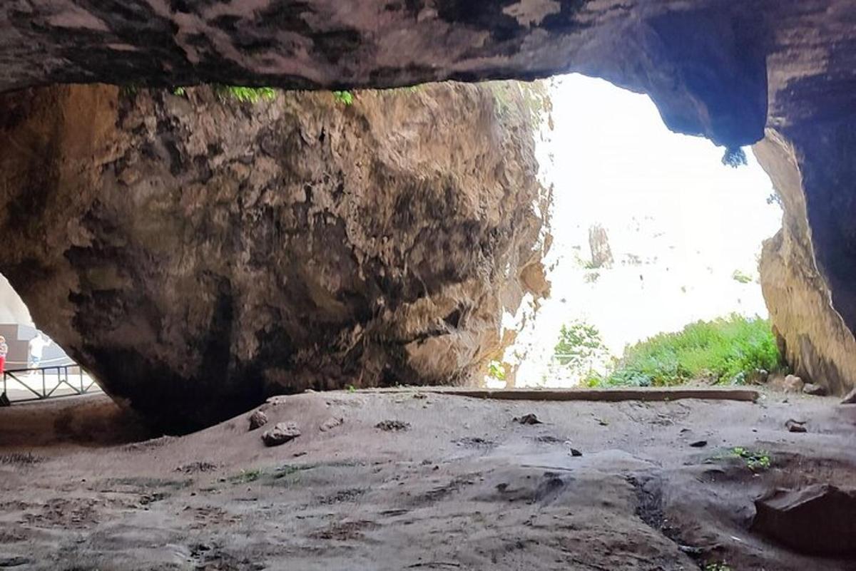 Una vista de una cueva con una gran roca.