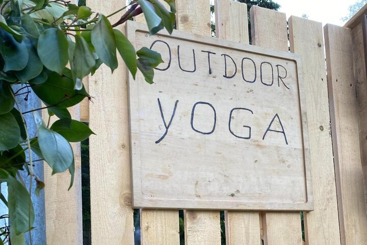 a sign on a fence that reads outdoor yoga