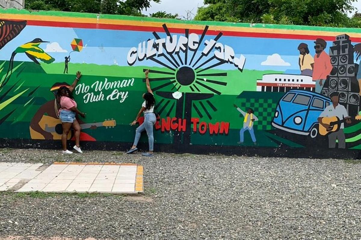 a mural on a wall with people standing in front of it
