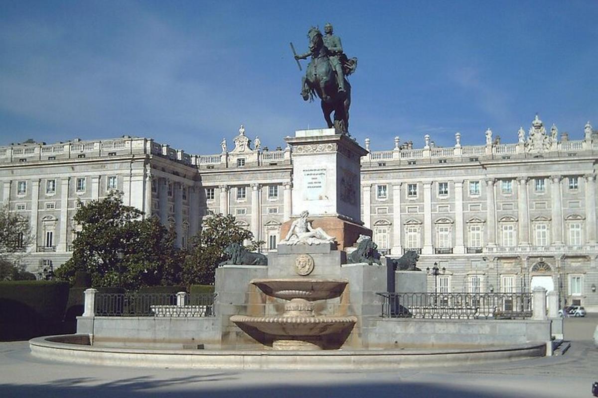a statue of a man on a horse in front of a building