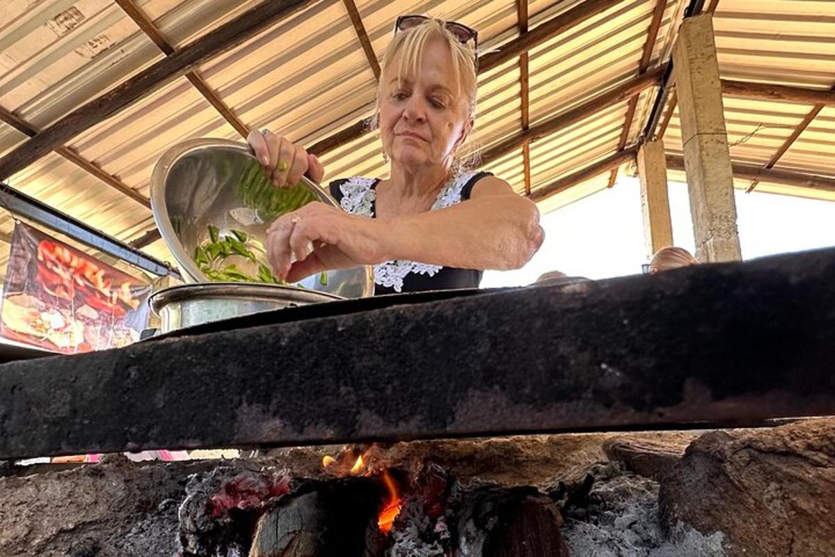 kobieta gotuje jedzenie w garnku nad ogniem