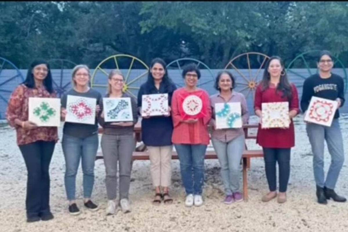 a group of women holding up signs in front of a bench