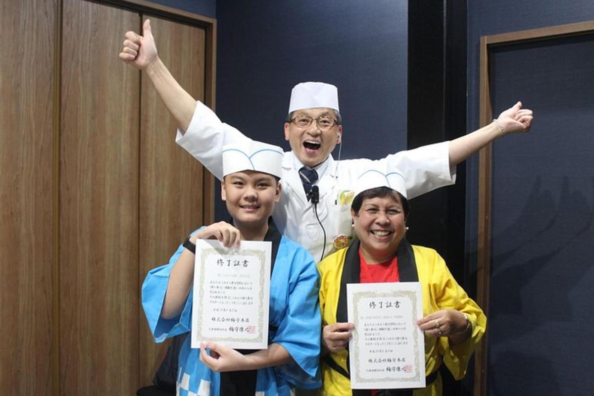 a man in a chefs hat is holding up certificates