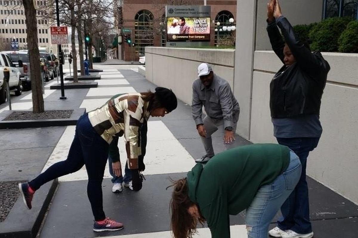 a group of people standing on a sidewalk