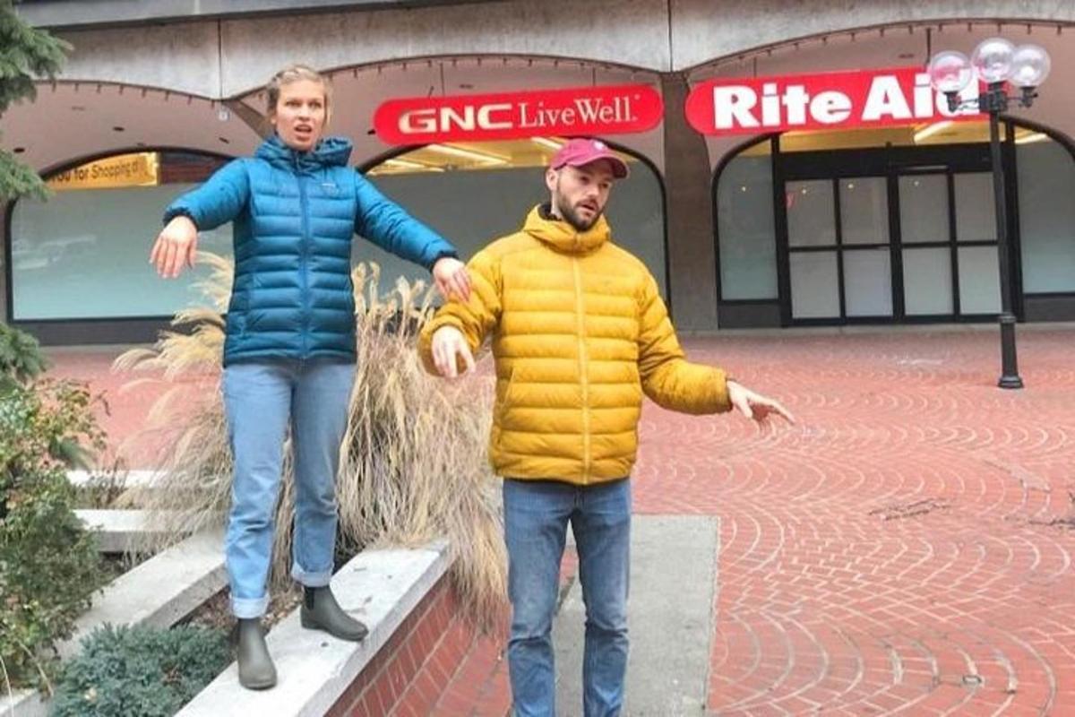 two people are standing in front of a building