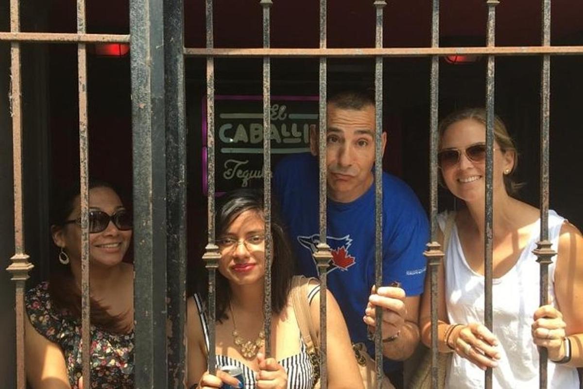 a group of people standing behind a gate