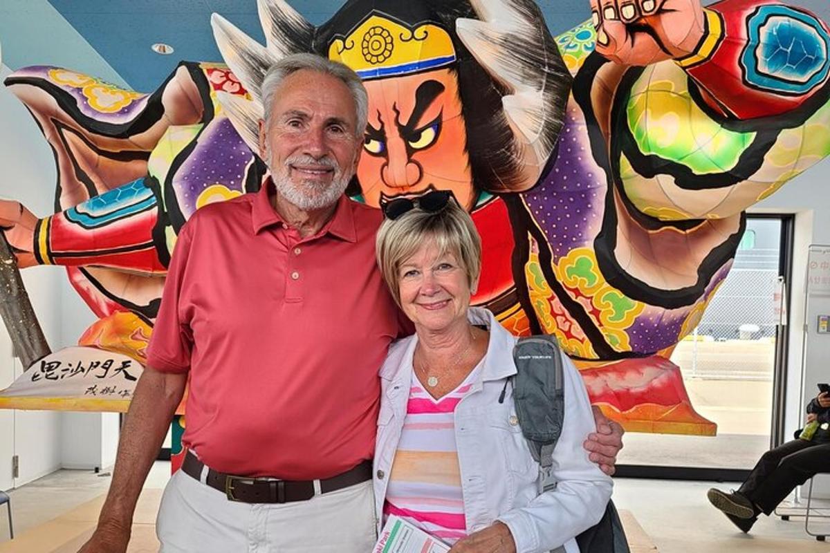 a man and a woman standing in front of a painting
