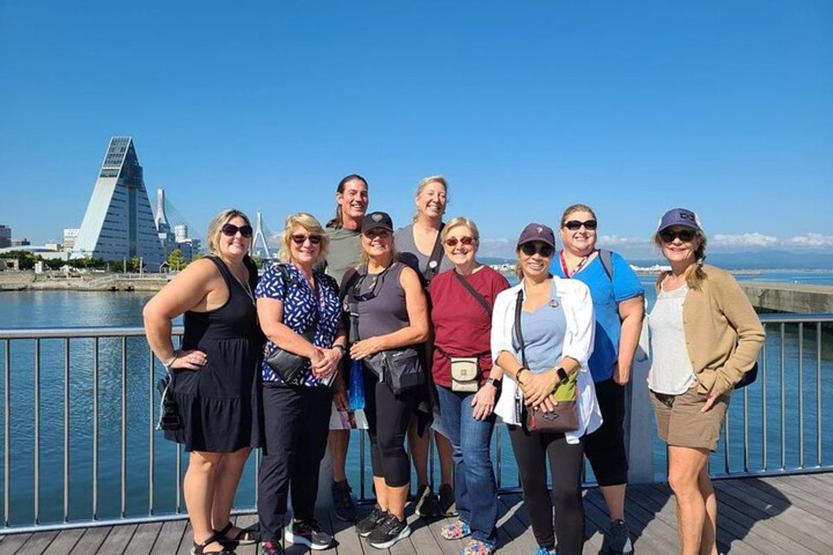 a group of people posing for a picture on a bridge