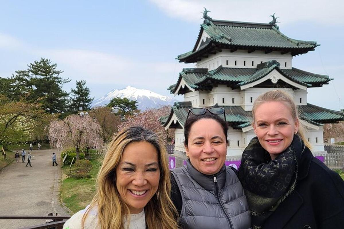 three women are standing in front of a building