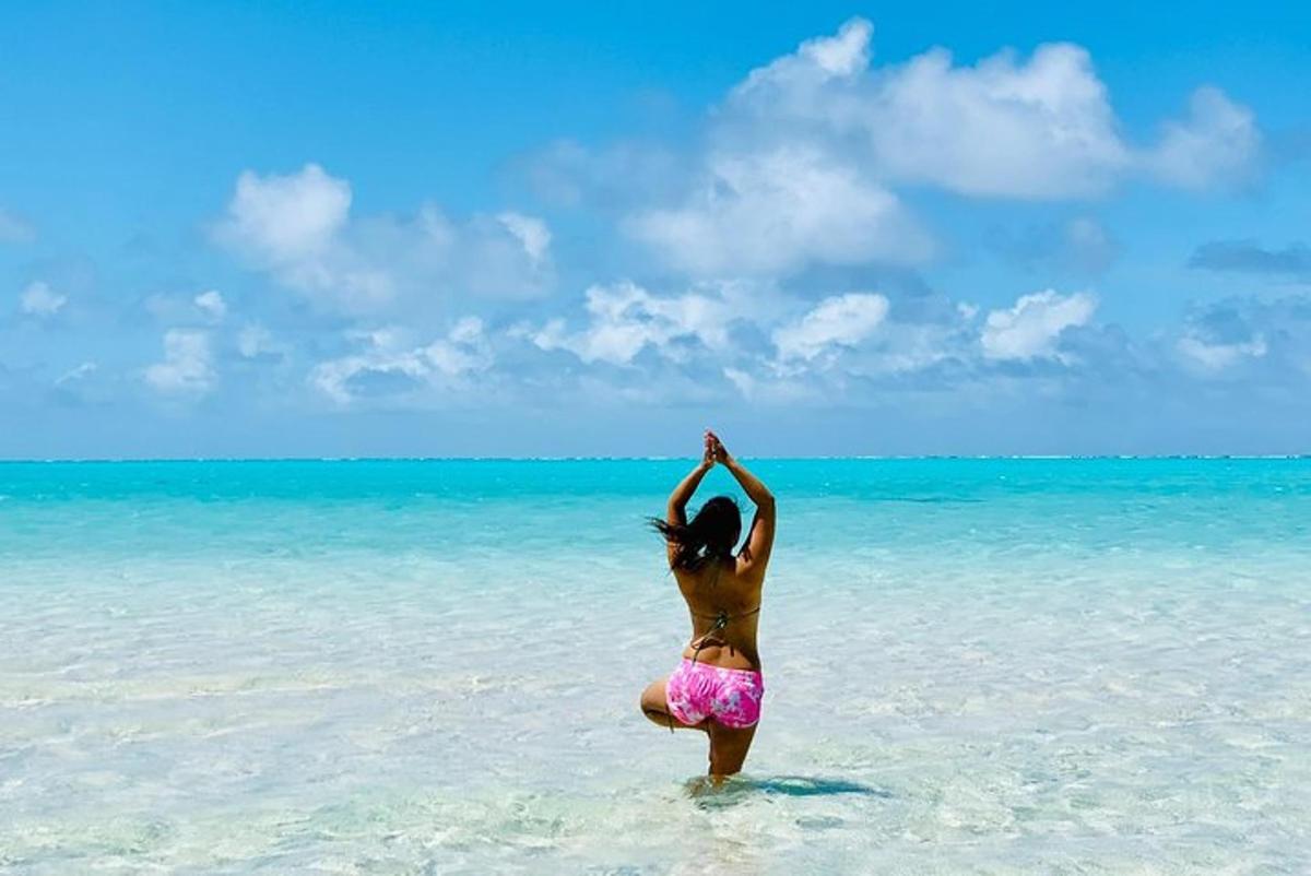 a woman standing in the water on the beach