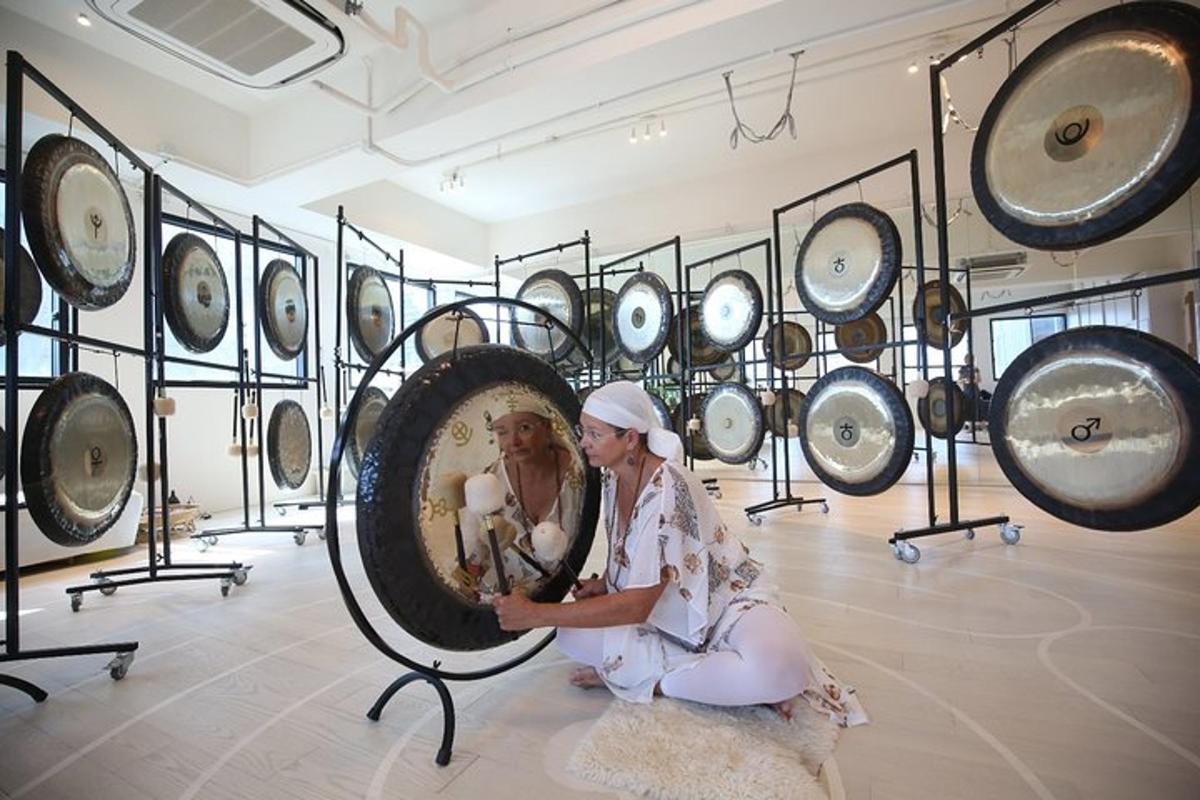 a woman sitting on the floor in front of a display of mirrors