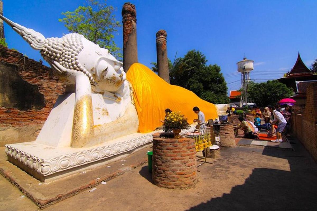 a large white statue of a bird on a street
