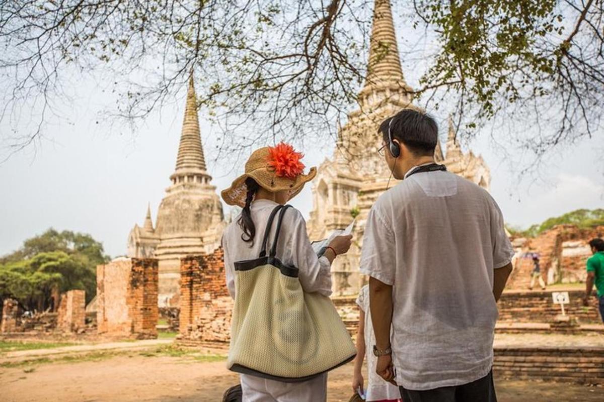 a man and a woman standing in front of a temple