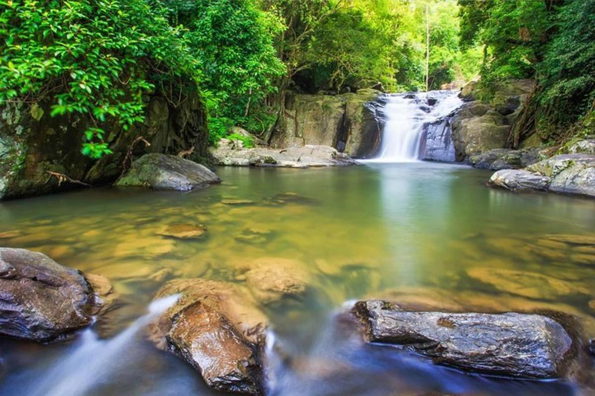 a waterfall in the middle of a river with rocks
