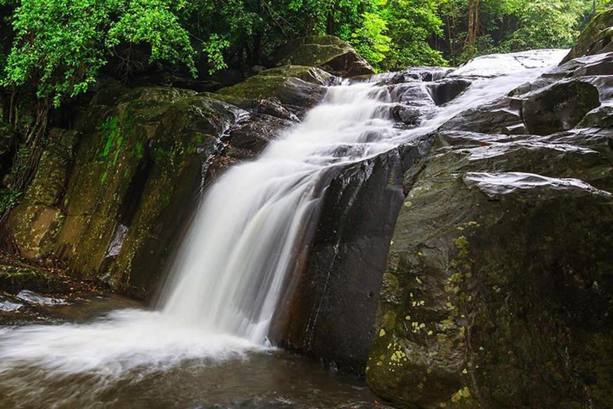 a waterfall on the side of a rocky river