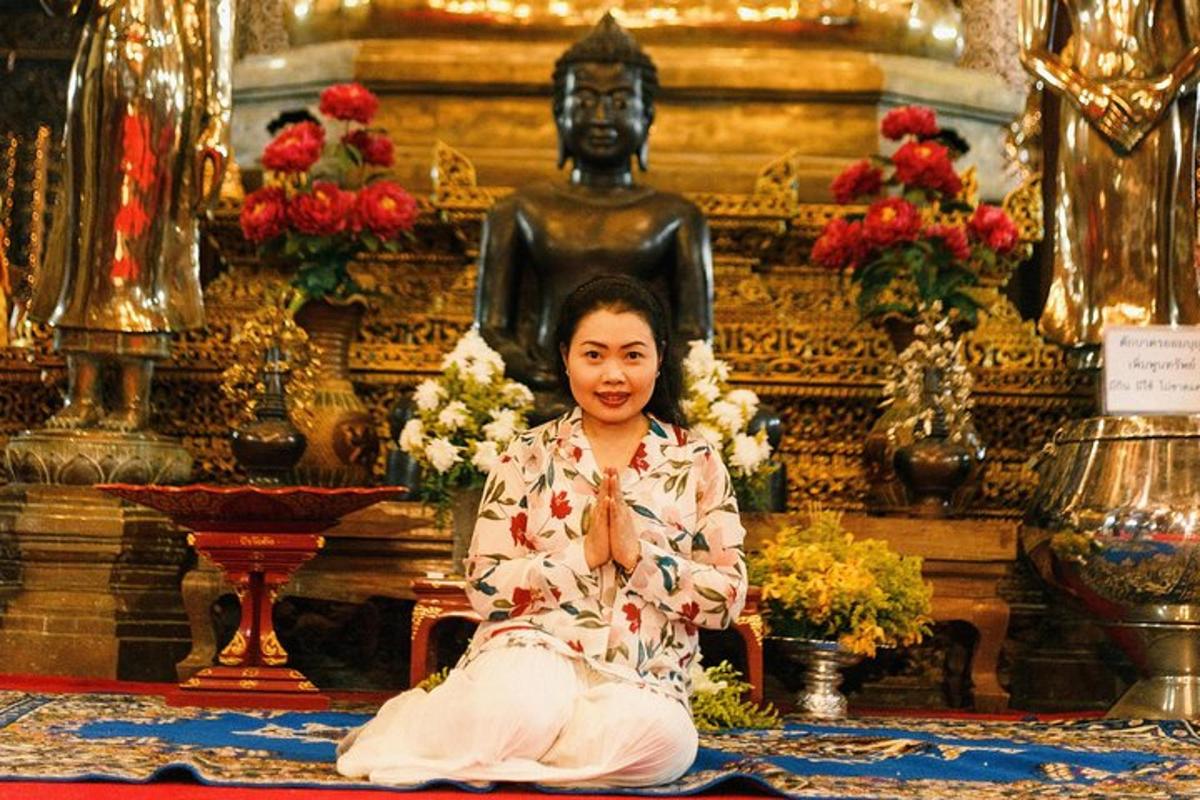 a young girl sitting in front of a statue