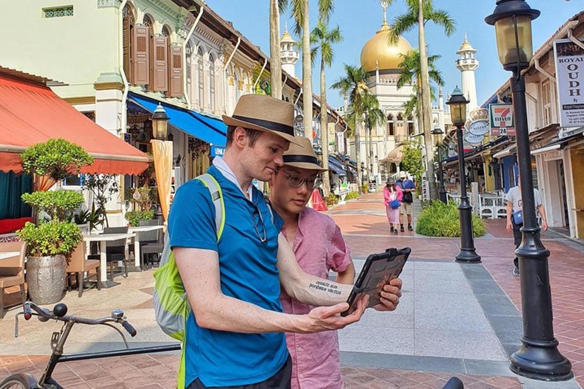 a man and a woman looking at a tablet on a street