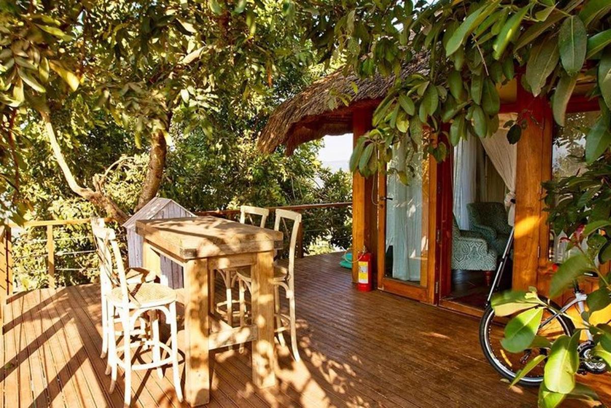 a wooden deck with a table and chairs on a house