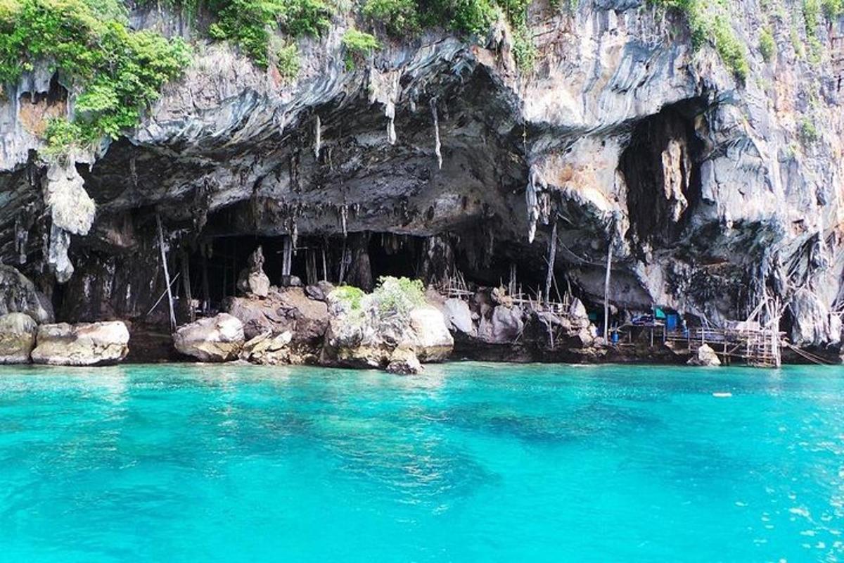 uma piscina de água azul em frente a uma caverna