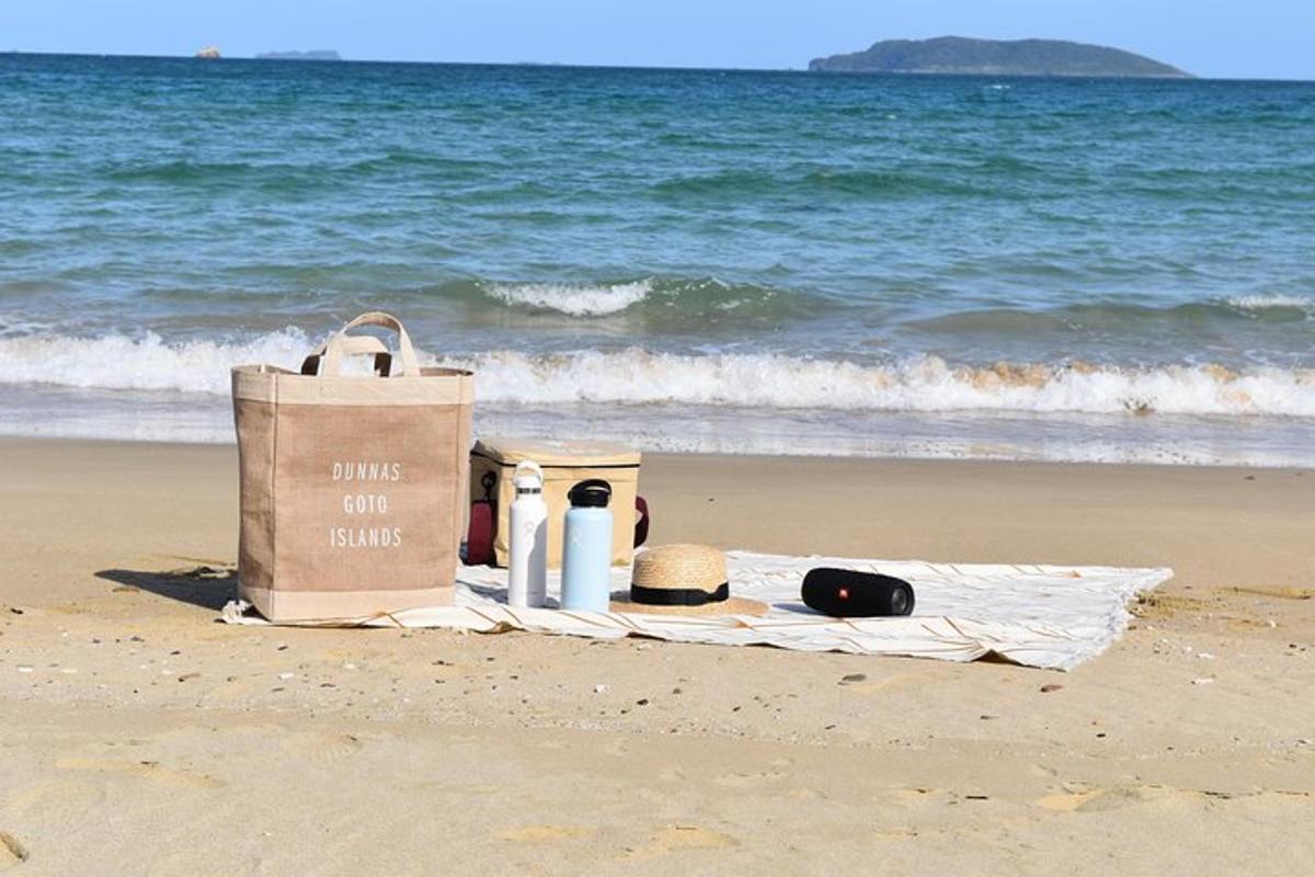 a bag and a towel on the beach