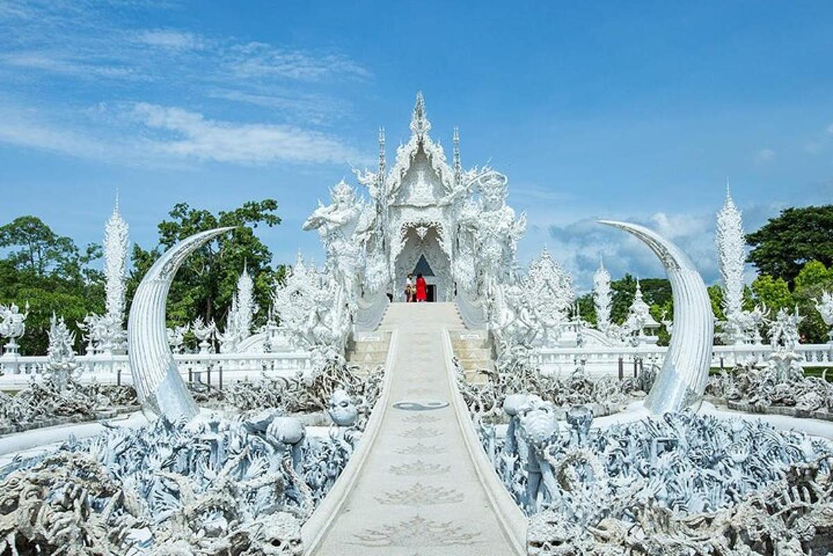 a person standing in front of a white temple