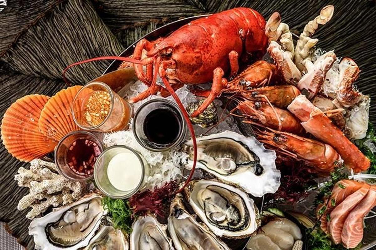 sepiring makanan berisi lobster dan makanan laut lainnya
