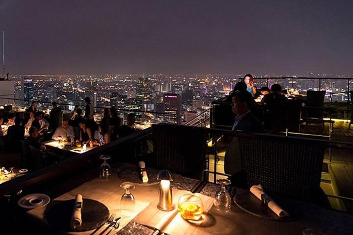 sekelompok orang yang duduk di restoran pada malam hari