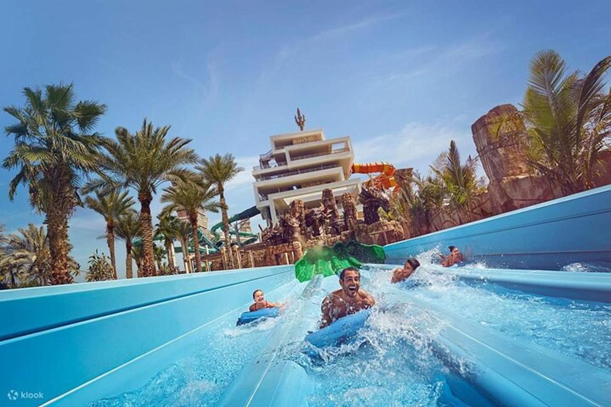 a group of people riding a water slide at a resort