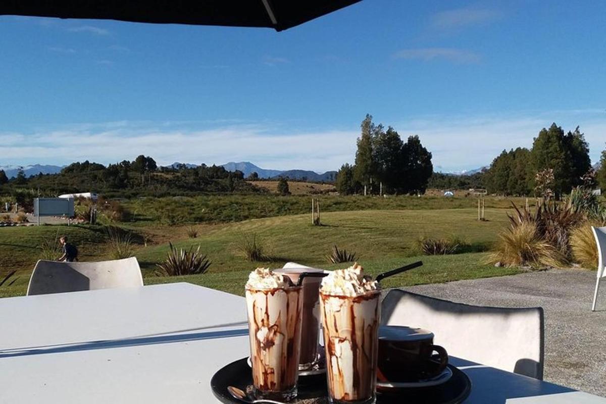two drinks on a table with a view of a field