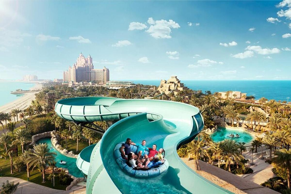 a group of people riding a water slide at a resort