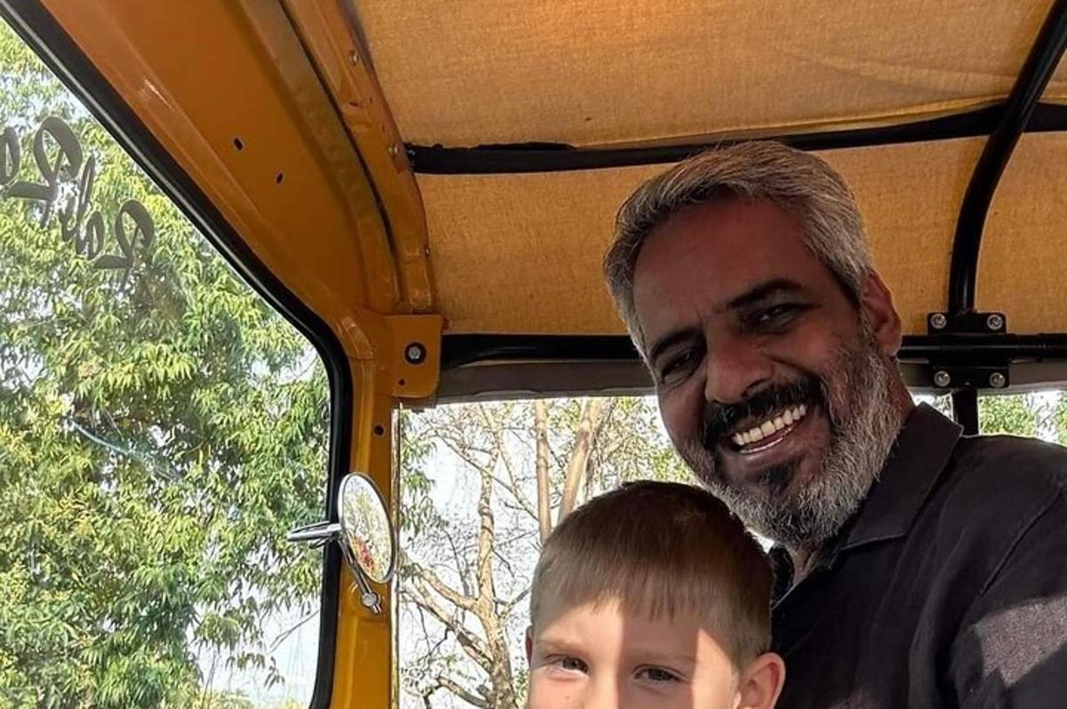 a man and a boy sitting in a vehicle