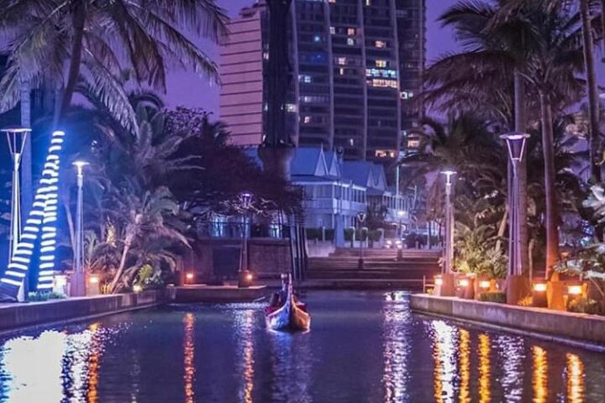 a boat in a pool in a city at night