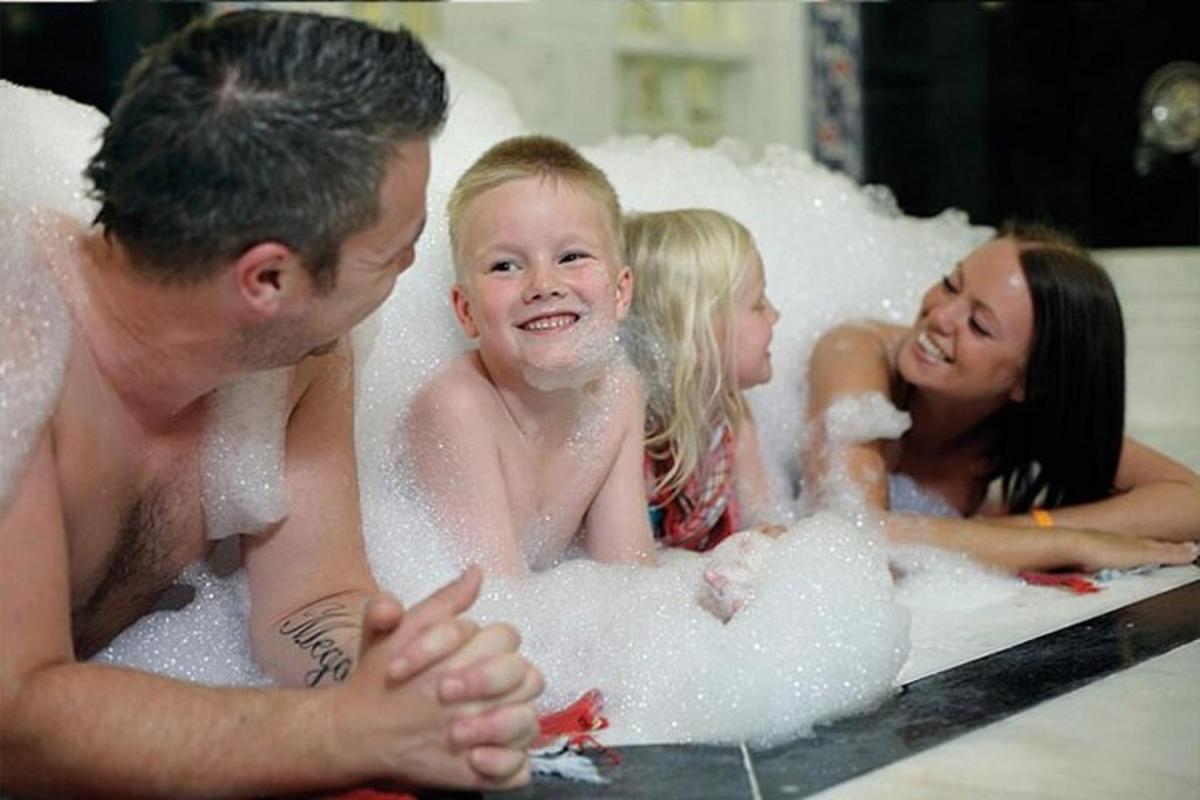 a group of people in a bath tub
