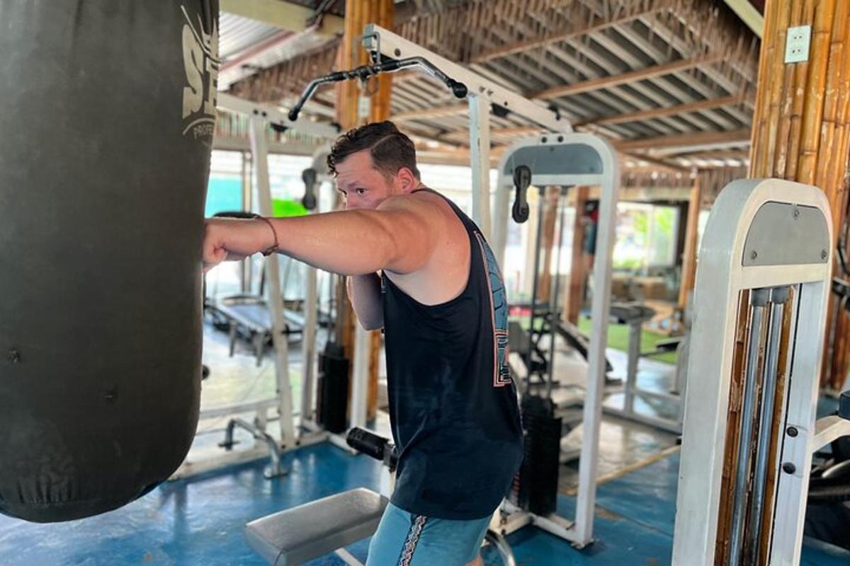 a man in a gym with a punching bag