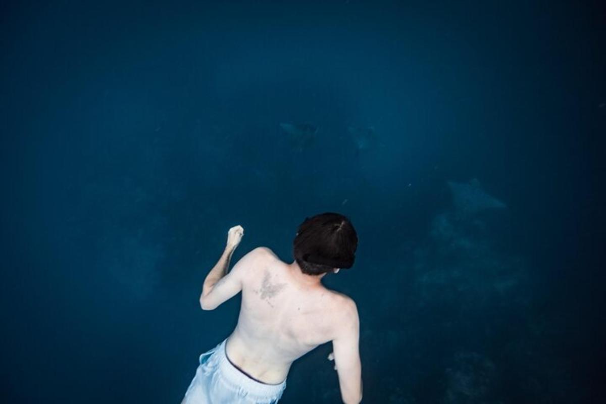 a man standing in the water in the ocean