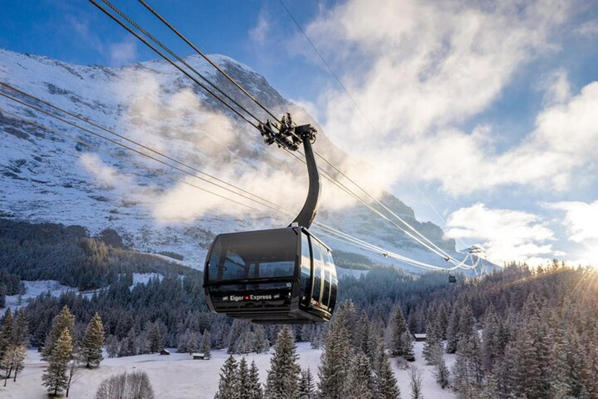a gondola flying over a snow covered mountain