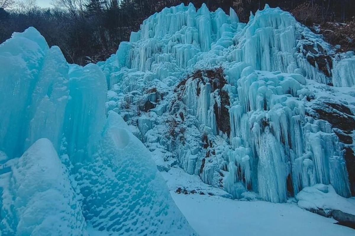 a large ice waterfall is covered in snow