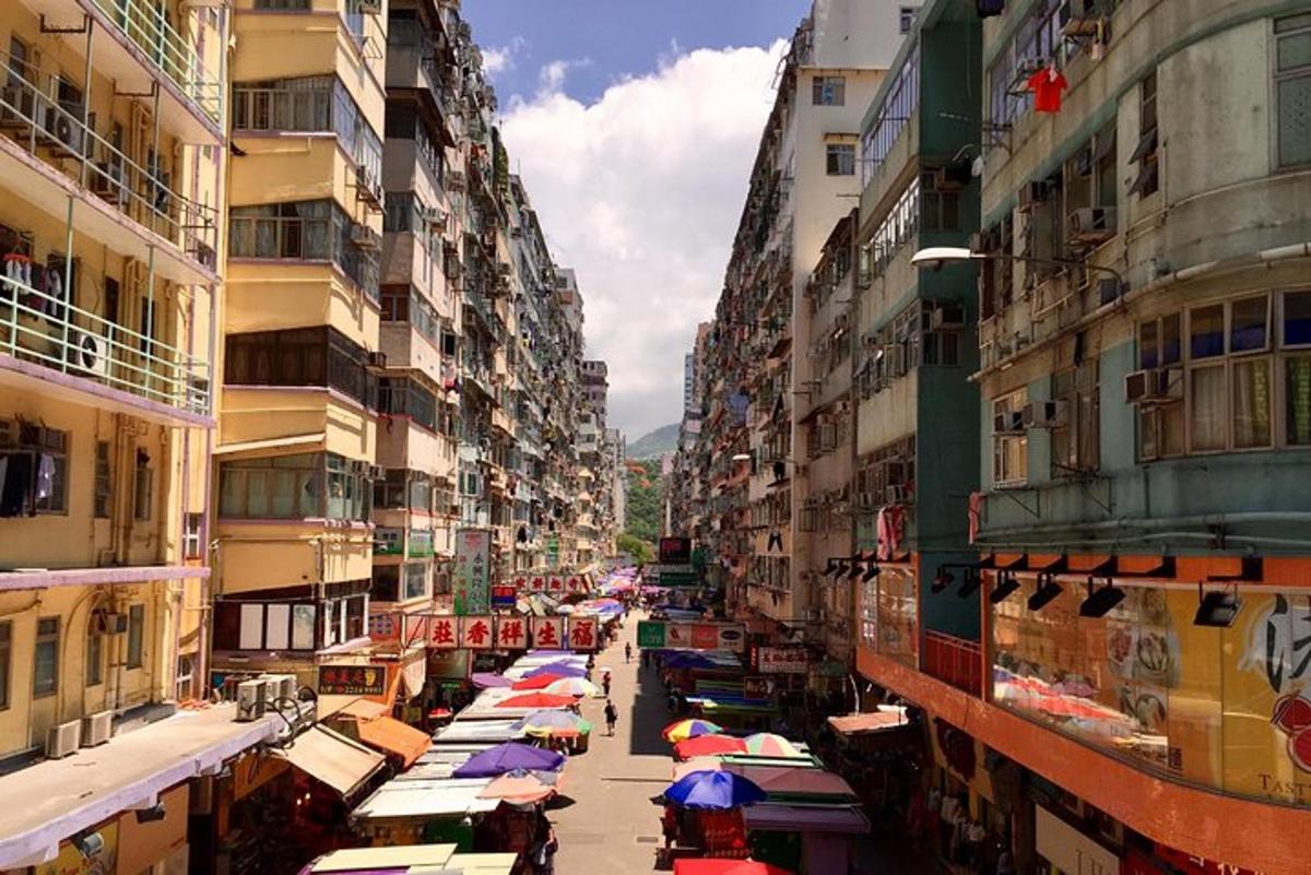 a city street with many umbrellas in the middle