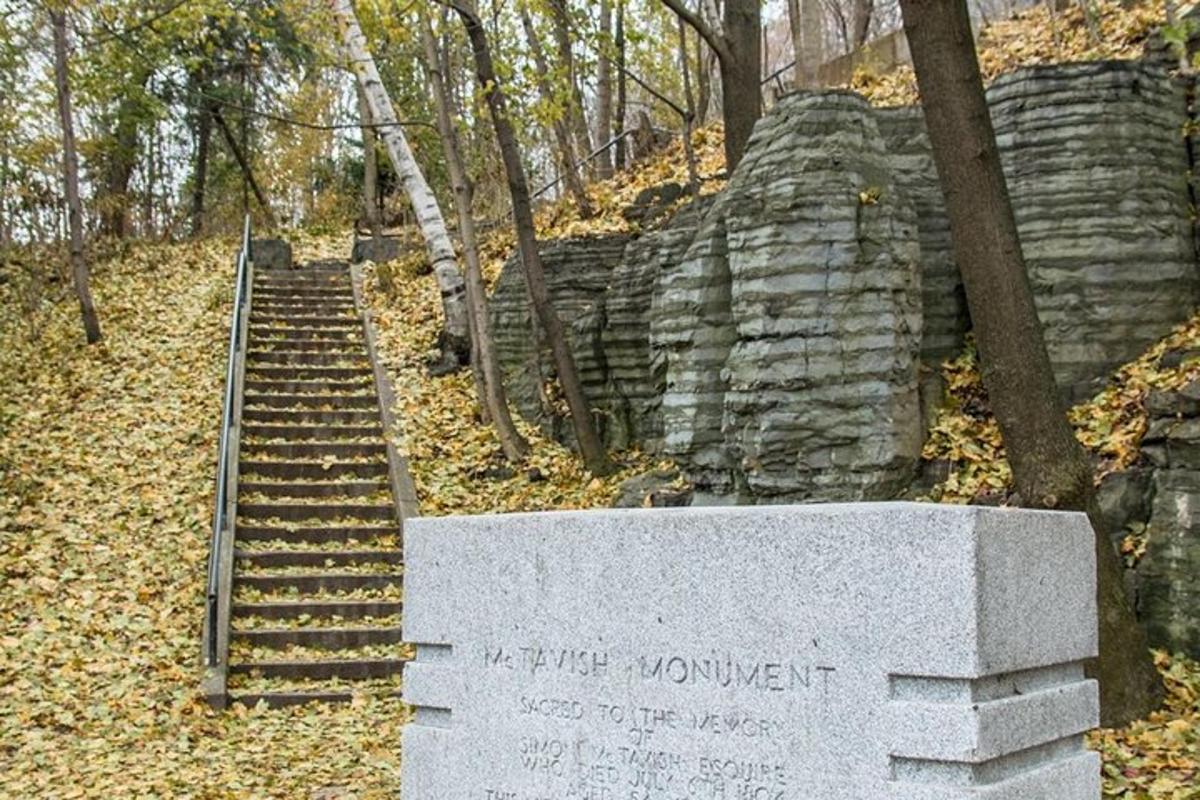 a stone monument with a staircase in the woods