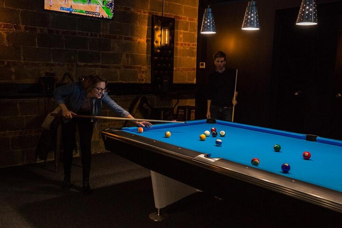 a man playing a game of pool in a room