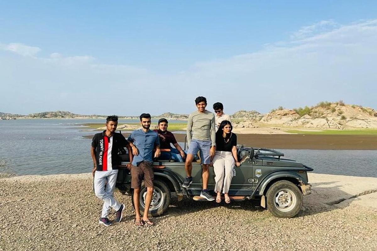 a group of people standing on the back of a car