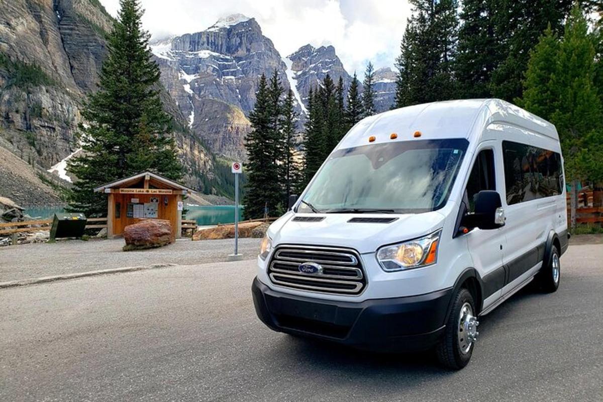 a white van parked in front of a mountain