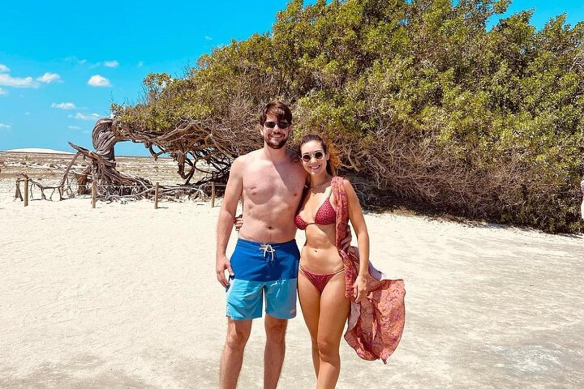 a man and a woman standing on a beach