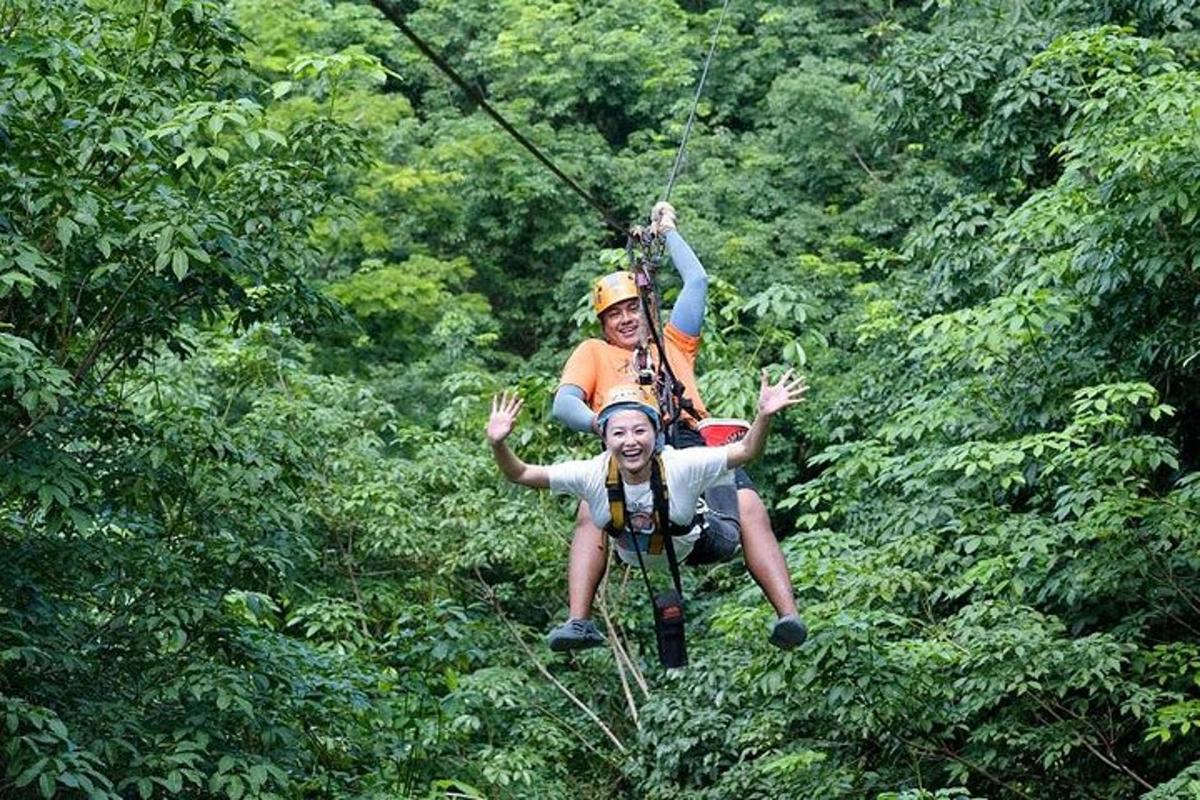 two people on a zip line in the jungle