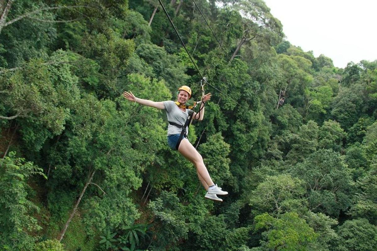a woman on a zip line in the jungle