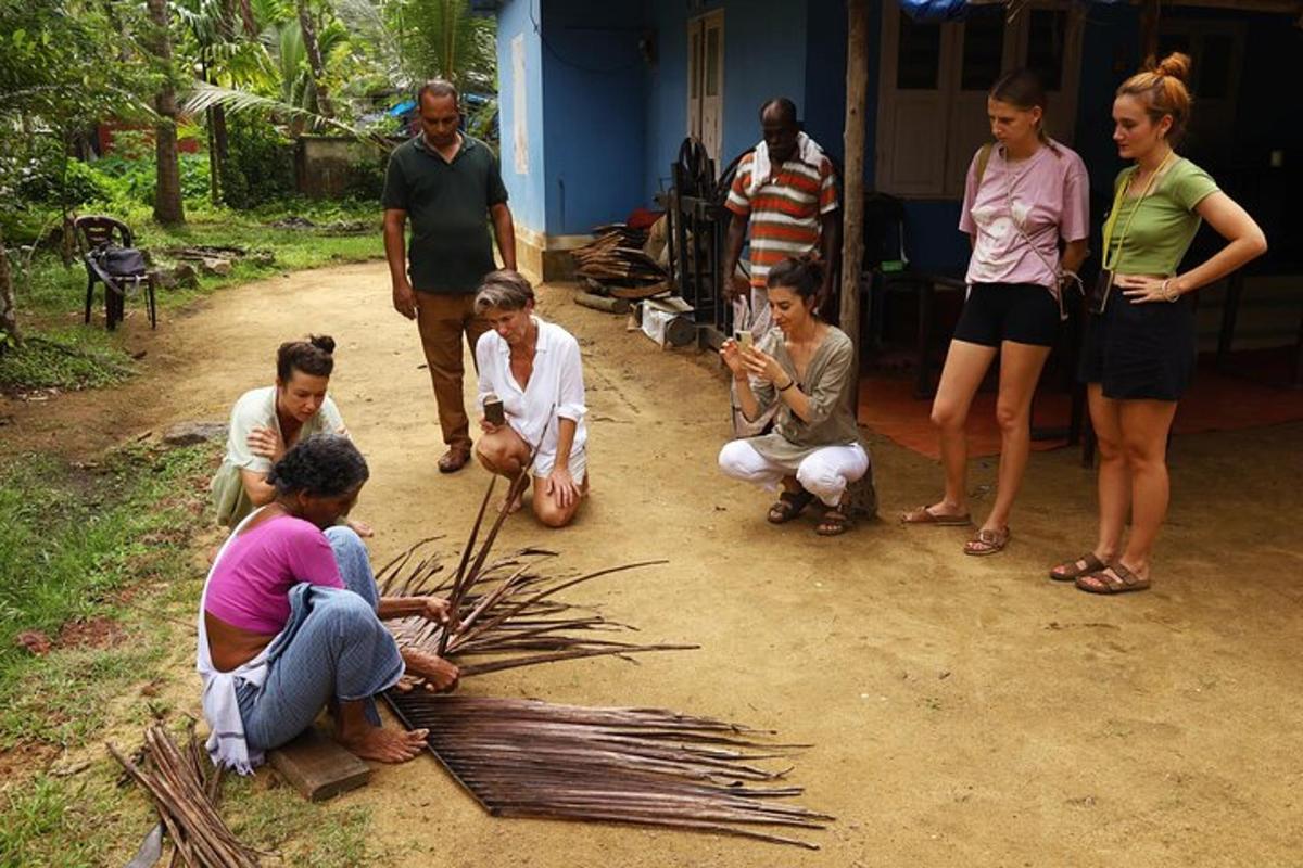 a group of people standing around a group of sticks