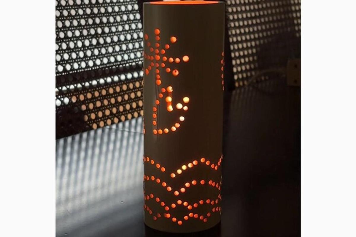 a black vase with a heart painted on it